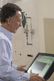 engineer adjusting settings on large scale supercritical fluid system