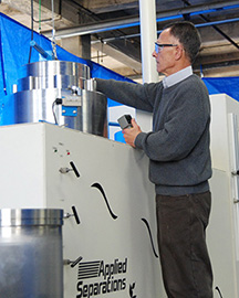 engineer putting the lid on a large high pressure supercritical fluid vessel